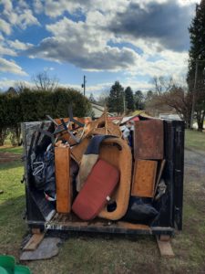 20 yard dumpster, house cleanout, filled, rear swing open door, Emmaus